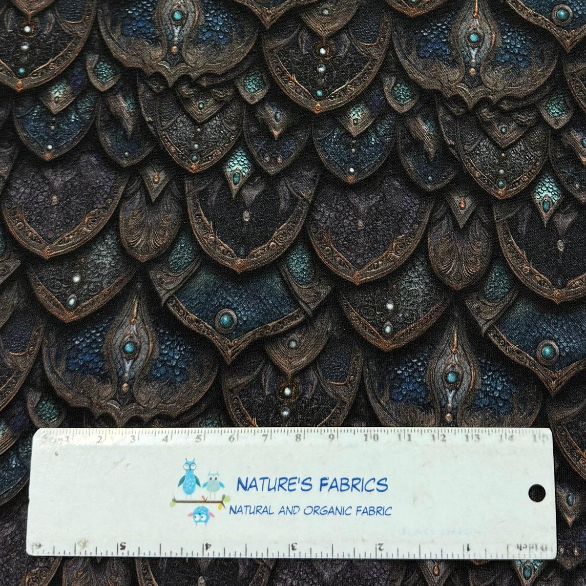 Nature's Fabrics dragon scale textured faux leather fabric in dark blue and bronze.