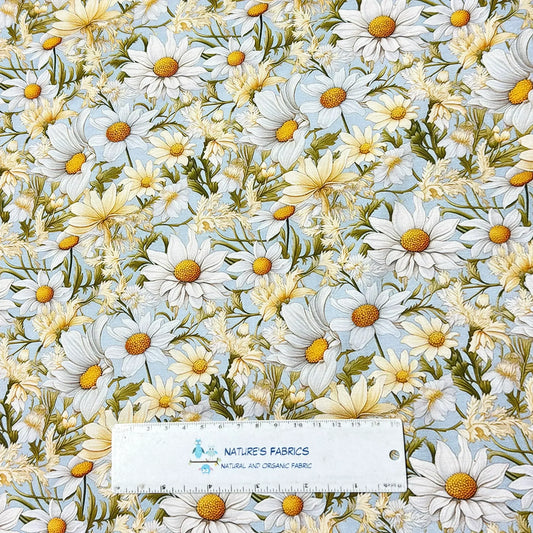 Nature's Fabrics organic cotton fabric with a white and yellow daisy floral pattern.