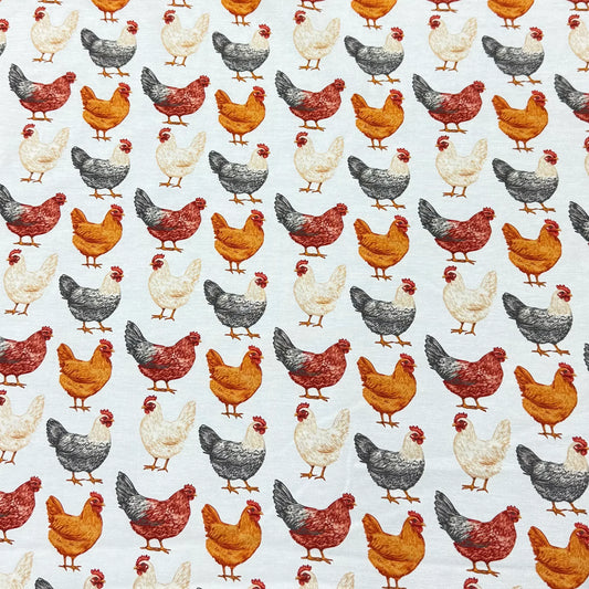 Nature's Fabrics organic cotton fabric with a repetitive pattern of red, orange, and grey chickens.