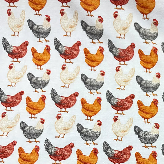Nature's Fabrics organic cotton fabric featuring a repeating pattern of colorful chickens.