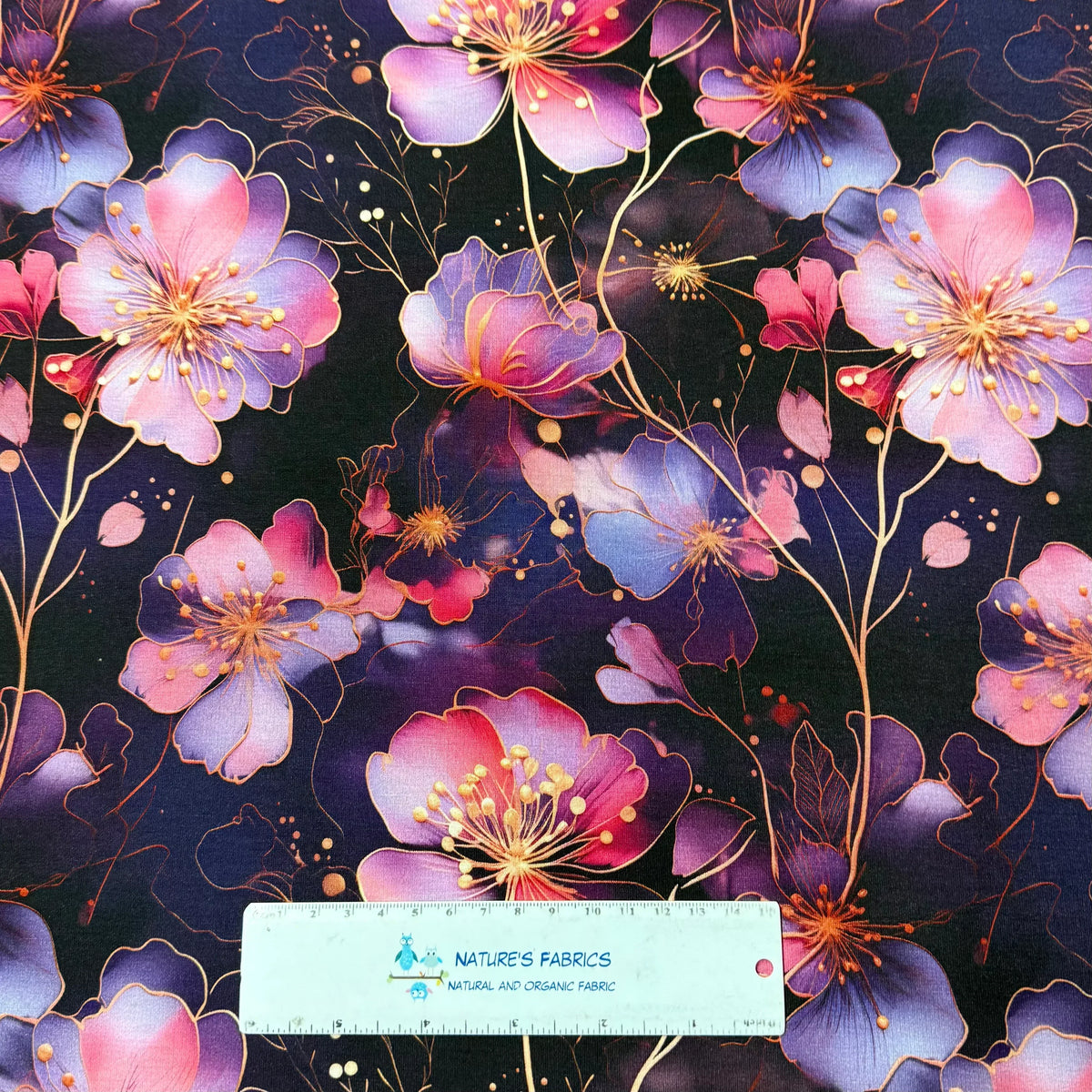 Nature's Fabrics floral print fabric with purple pink blossoms on dark background, organic cotton by the yard