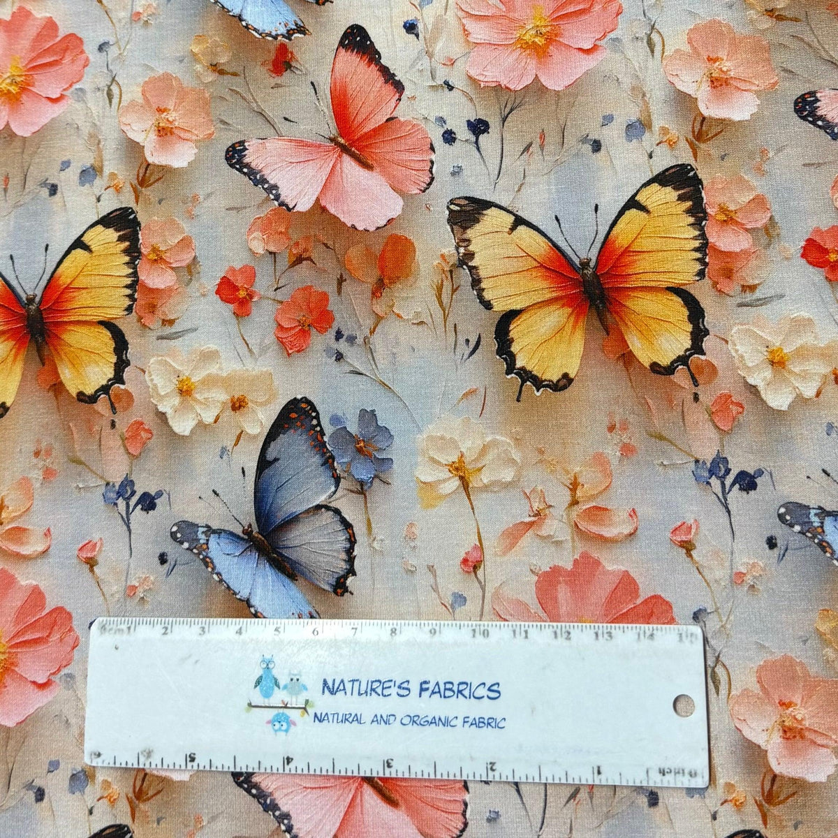 Nature's Fabrics butterfly and floral print organic cotton fabric with ruler for scale