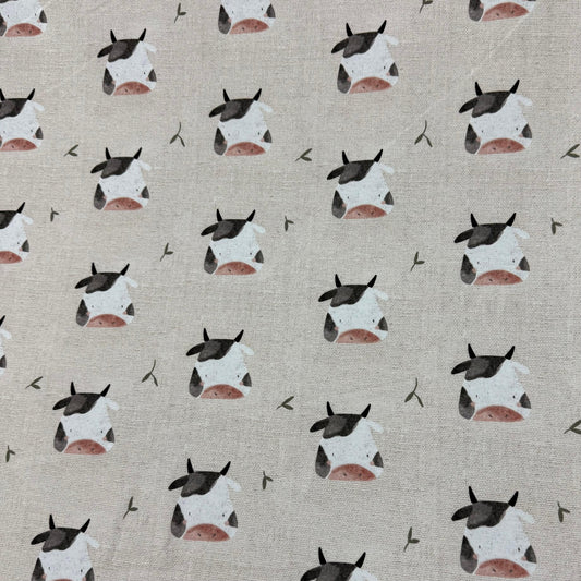 Nature's Fabrics cream-colored organic cotton fabric with a cute cow print pattern