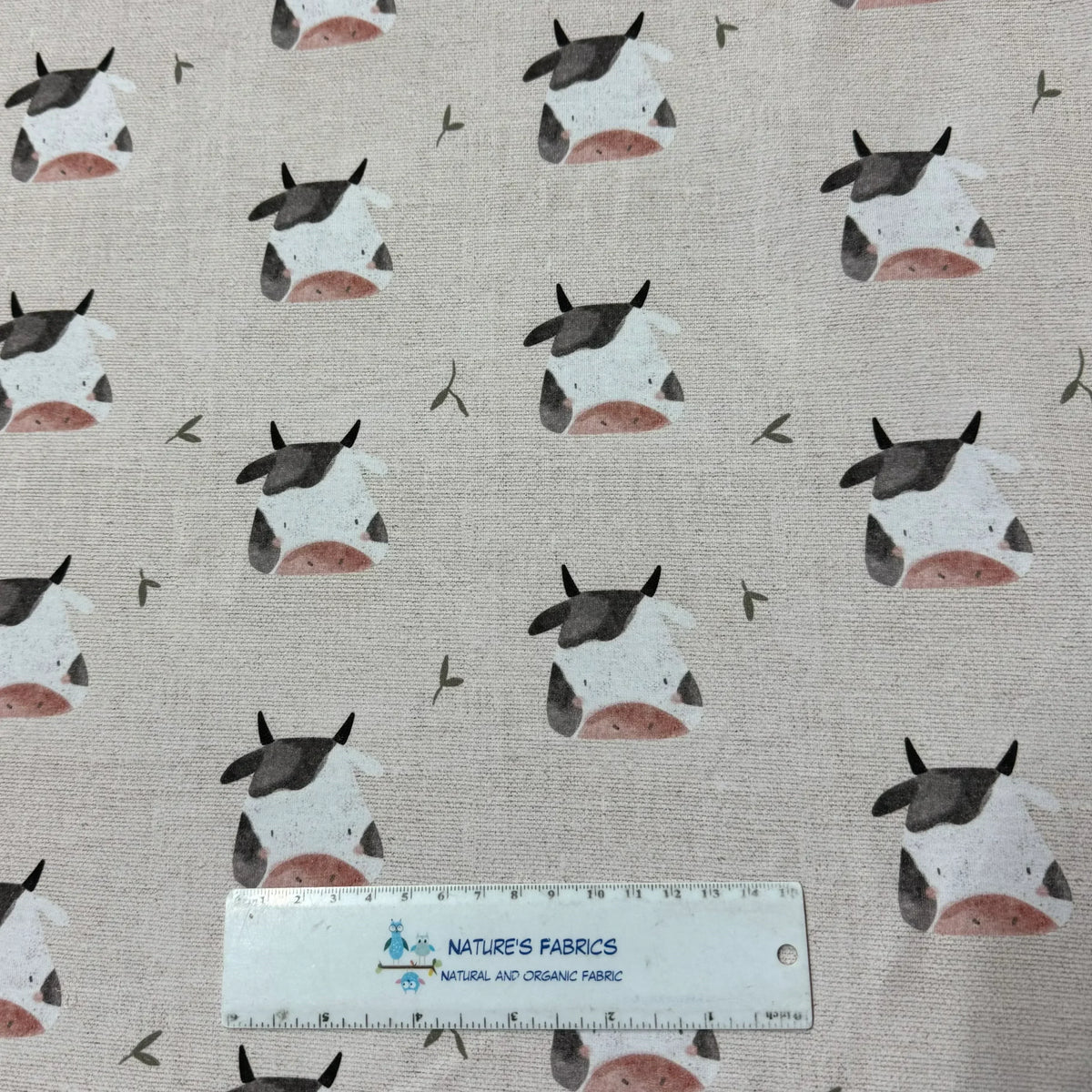 Cute cow print fabric by Nature's Fabrics, natural organic cotton with playful black & white cows on beige background