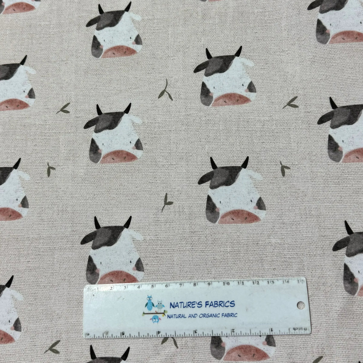 Cute cow print organic cotton fabric by Nature's Fabrics, natural and eco-friendly textile with ruler for scale