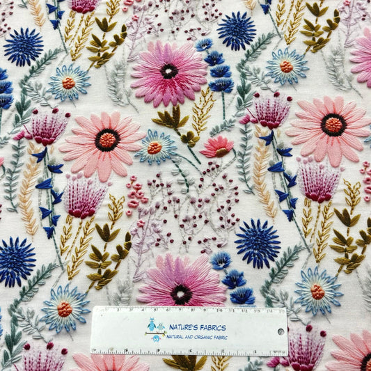 Embroidered floral fabric with colorful blossoms from Nature's Fabrics.