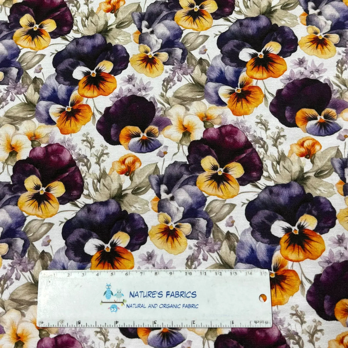 Nature's Fabrics purple and yellow pansy floral print organic cotton fabric with ruler for scale