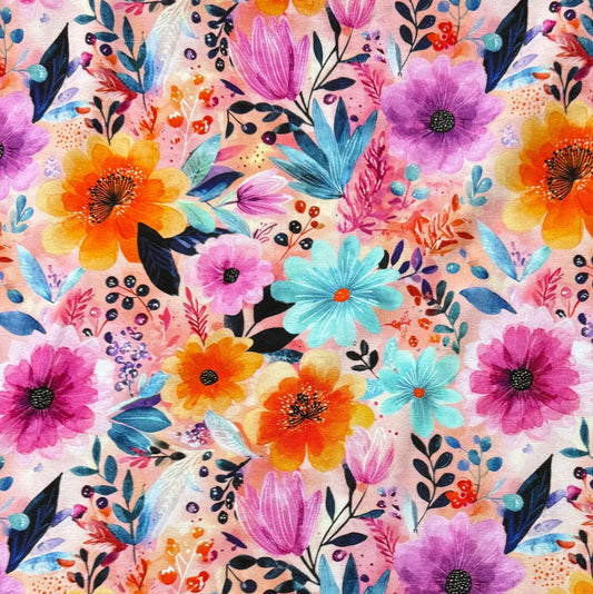 Nature's Fabrics premium fabric with a colorful watercolor floral print in pink, orange, and blue.