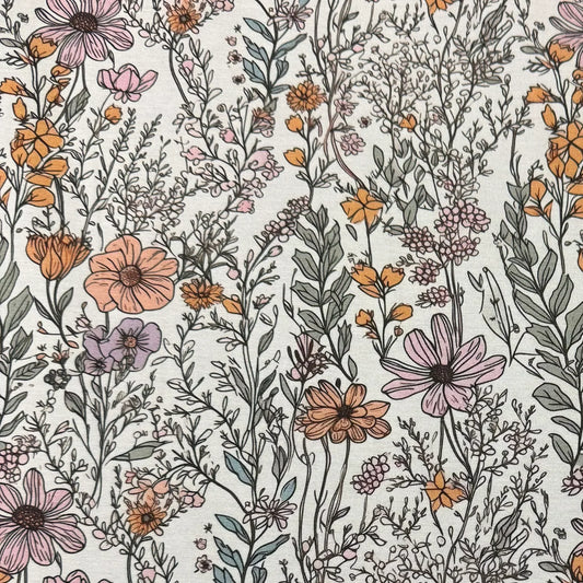 Nature's Fabrics botanical print fabric with orange, pink, and purple wildflowers on white.