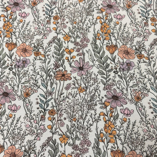 Nature's Fabrics floral print fabric with pink and orange wildflowers on off-white background