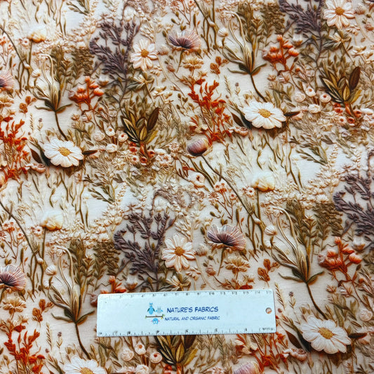Nature's Fabrics floral embroidered fabric with a ruler for scale.