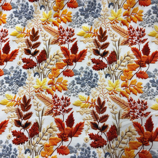Nature's Fabrics floral embroidered fabric with autumn orange and blue leaves on white background