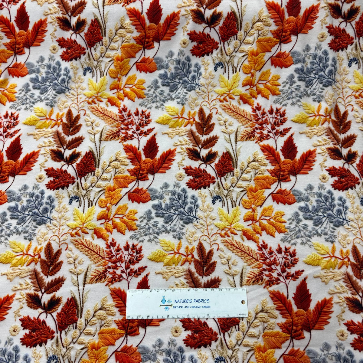 Nature's Fabrics autumn leaf embroidery on natural fabric, organic cotton with fall colors
