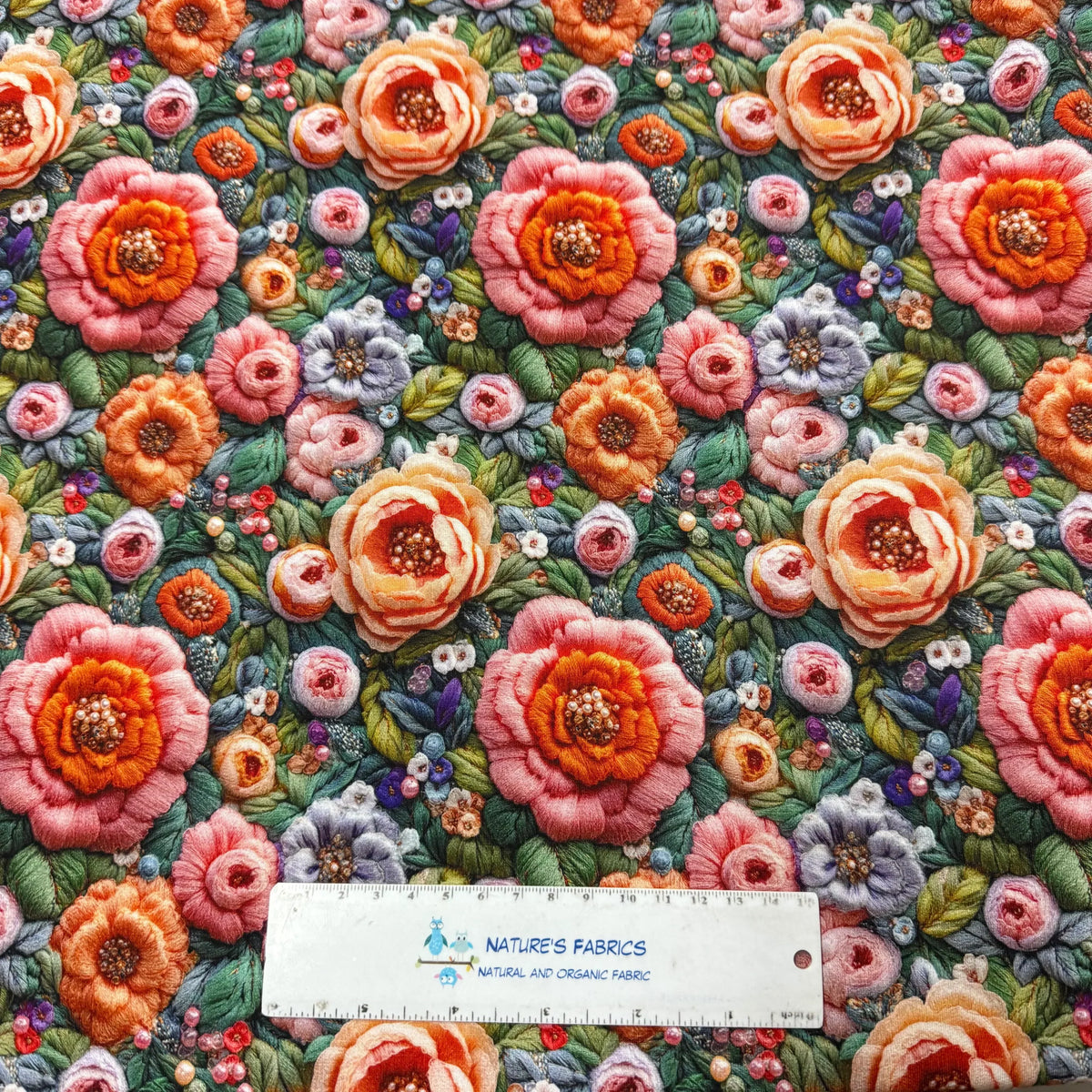 Nature's Fabrics floral embroidered organic cotton fabric with vibrant roses and greenery