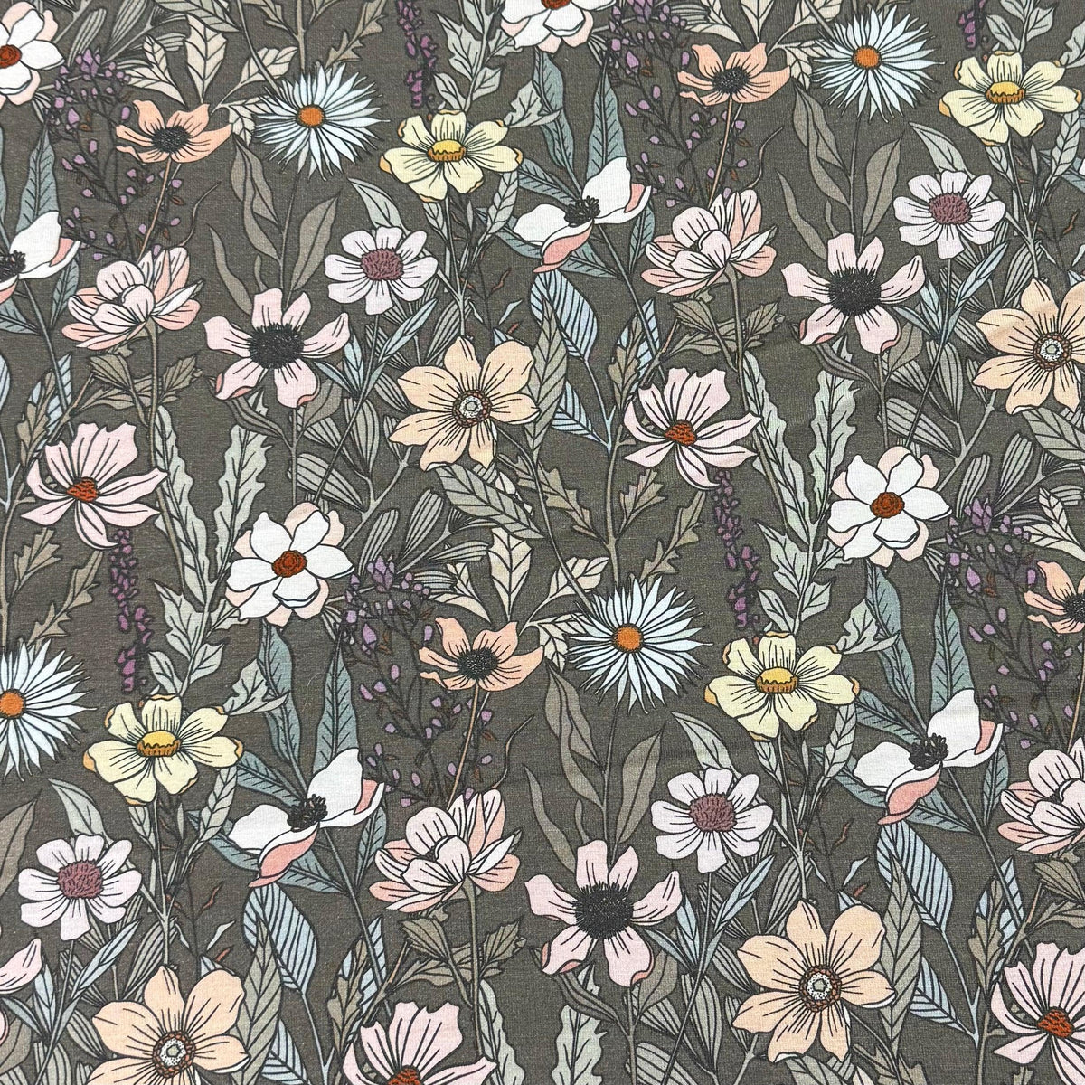 Nature's Fabrics floral print fabric with wildflowers and greenery on dark background