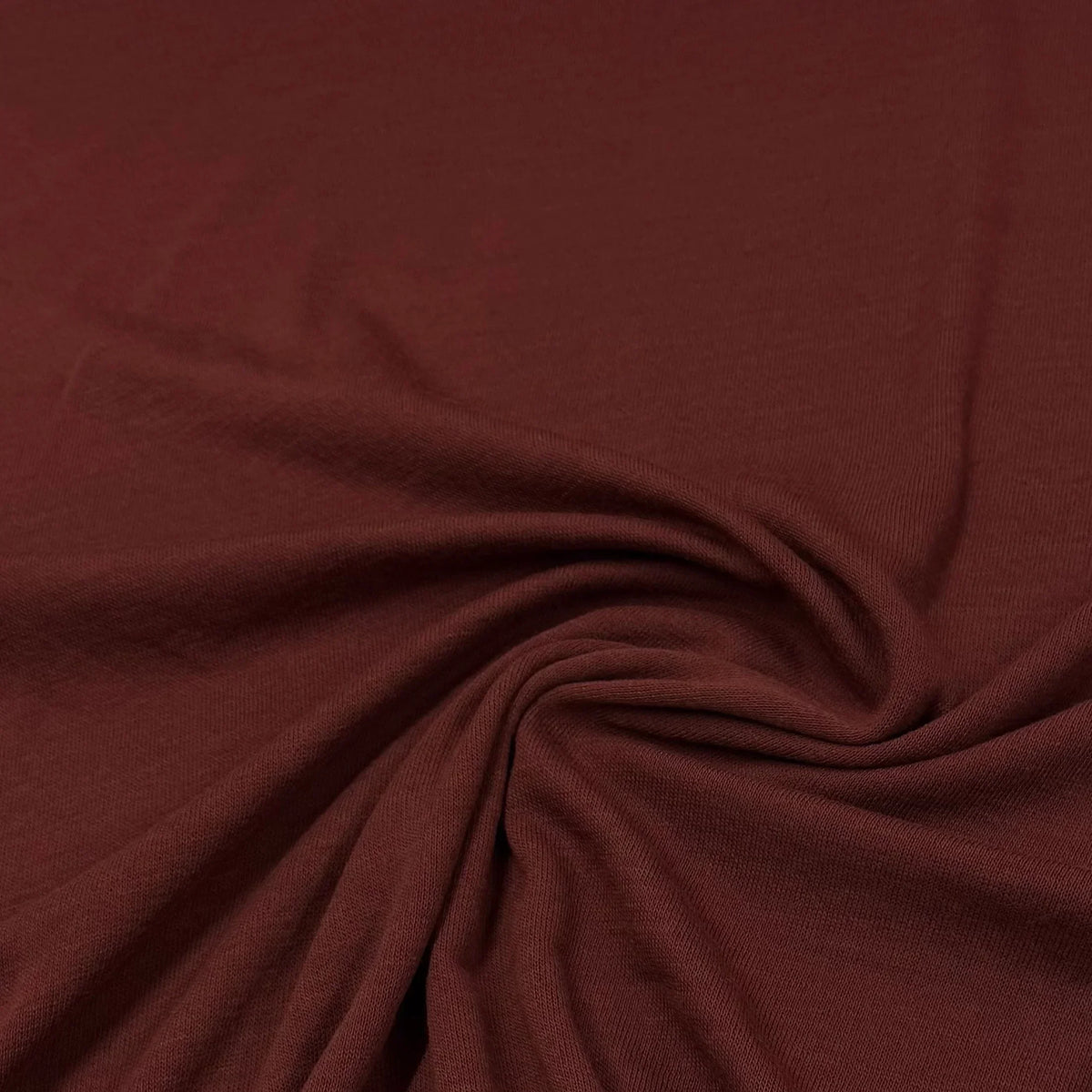 Rich burgundy organic cotton knit fabric by Nature's Fabrics, soft texture ideal for eco-friendly sewing projects
