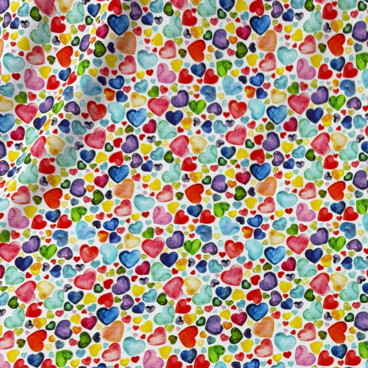 Colorful heart-patterned fabric by Nature's Fabrics, perfect for crafting and sewing projects.