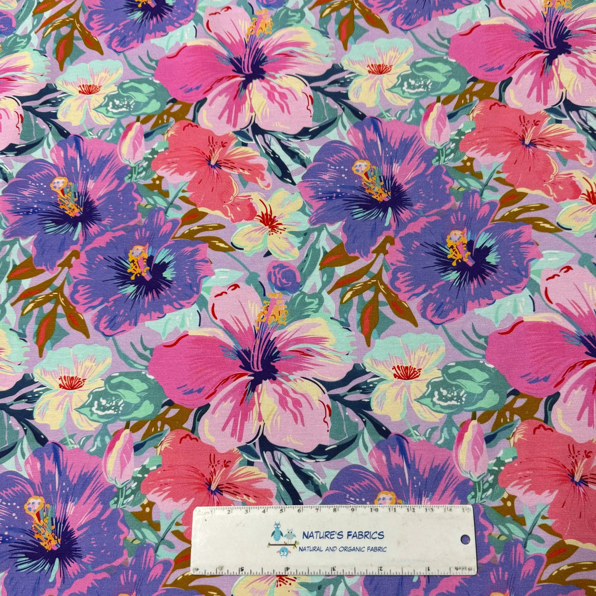 Nature's Fabrics colorful floral print fabric with pink and purple hibiscus flowers