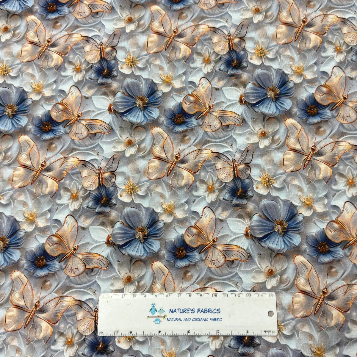 Nature's Fabrics blue floral and butterfly print organic cotton fabric with ruler for scale