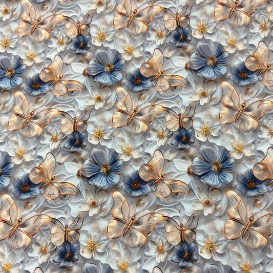 Nature's Fabrics pattern featuring golden butterflies and blue floral motifs on white fabric.