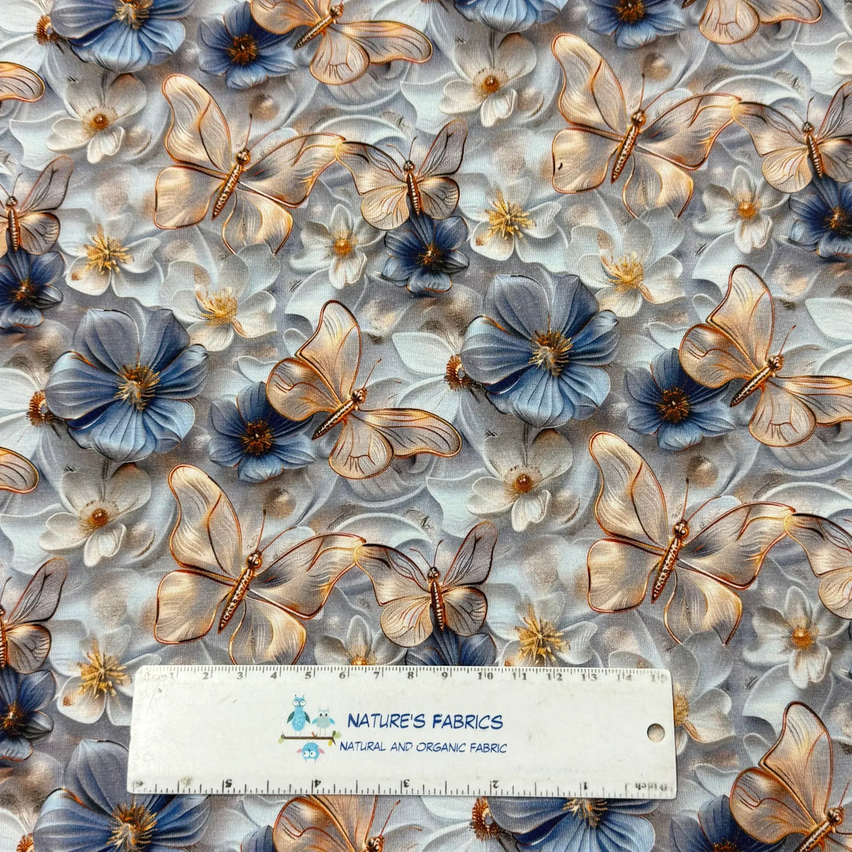 Nature's Fabrics butterfly and floral print organic cotton fabric with blue flowers and gold butterflies