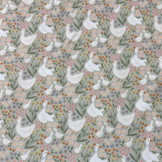 Nature's Fabrics white geese floral print cotton fabric with pastel flowers and greenery