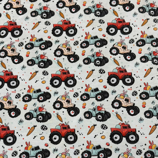 Easter monster truck print fabric by Nature's Fabrics — colorful trucks, carrots, eggs on natural cotton