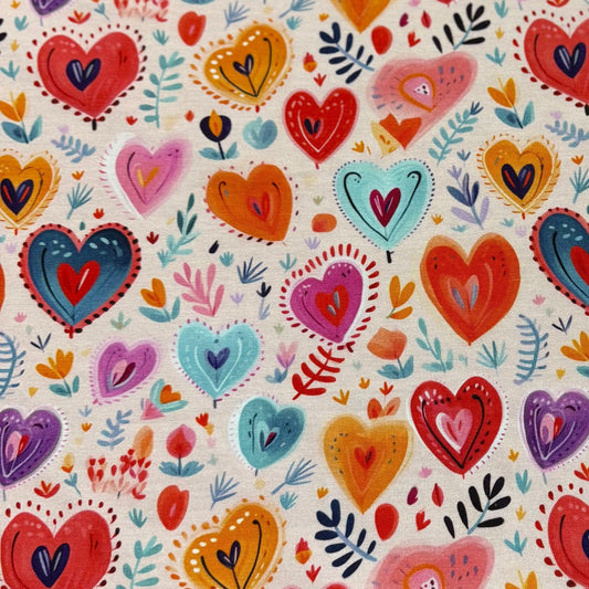 Colorful hand-drawn heart pattern on natural fabric from Nature's Fabrics.