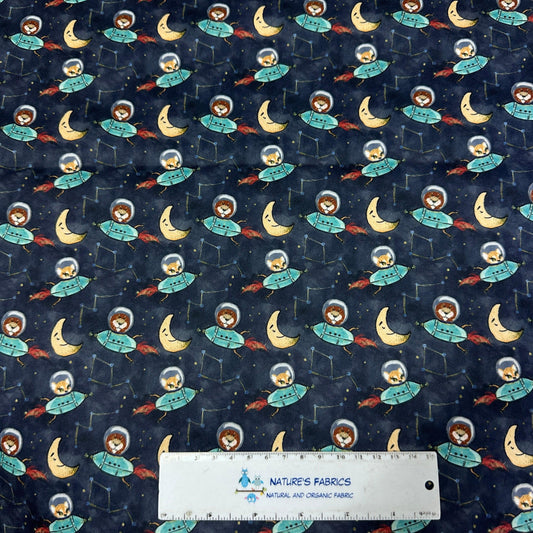 Nature's Fabrics organic cotton fabric with blue space, astronaut, and moon pattern.