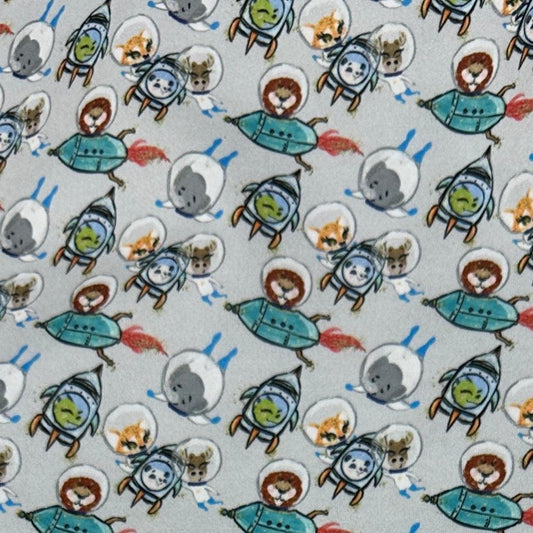 Nature's Fabrics light gray fabric with cute cartoon astronauts and rocket ships pattern