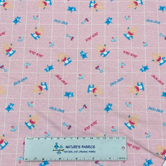 Nature's Fabrics pink organic cotton fabric with Jack-Jack print and a measurement ruler.