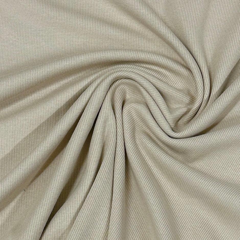 Nature's Fabrics beige ribbed natural fabric draped in soft folds