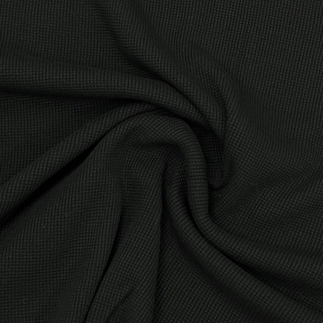Close-up of black waffle knit fabric from Nature's Fabrics.