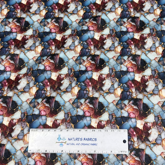 Nature's Fabrics abstract marble print organic fabric with blue, red, and gold tones.