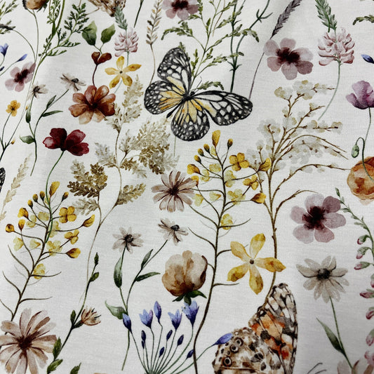 Nature's Fabrics organic cotton with a botanical print of wildflowers and butterflies.