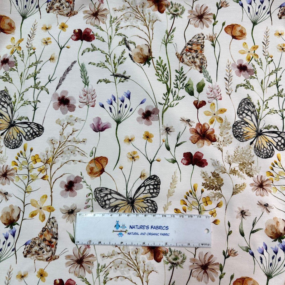 Nature's Fabrics floral print fabric with butterflies and wildflowers.