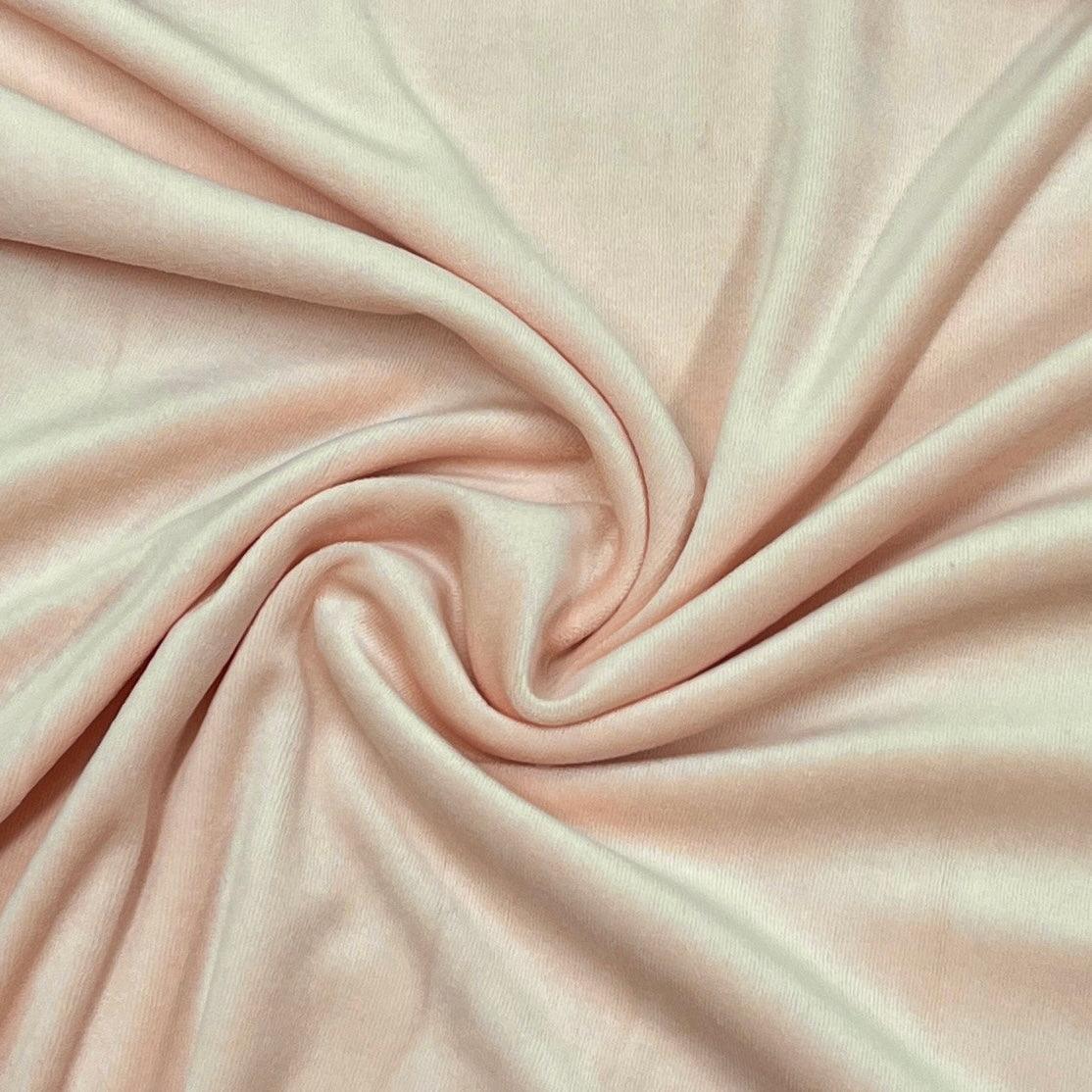 Close-up of soft, draped pale pink natural fabric from Nature's Fabrics.