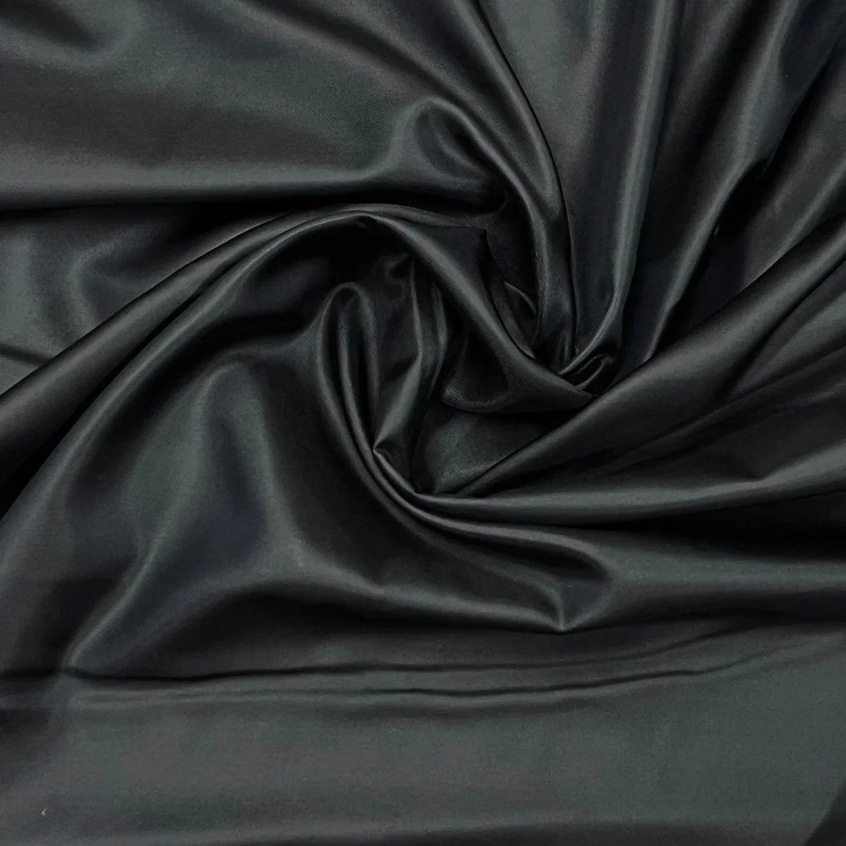 Close-up of draped, shimmering black satin fabric from Nature's Fabrics.