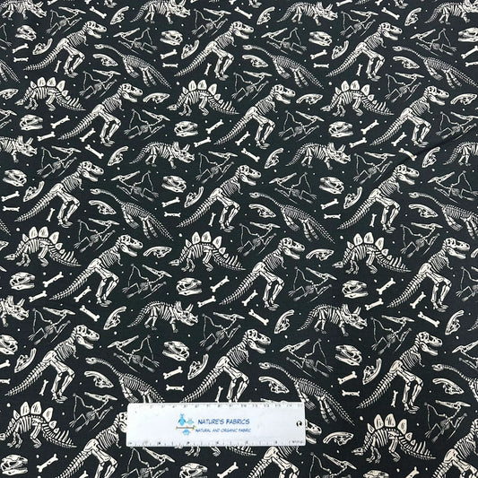 Nature's Fabrics black organic cotton fabric with white dinosaur skeleton pattern