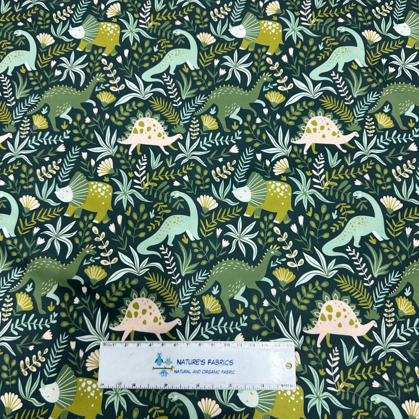 Dinosaurs on Green 1 mil PUL Fabric - Made in the USA - Nature's Fabrics