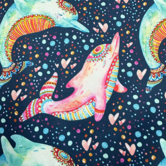 Nature's Fabrics colorful patterned fabric featuring psychedelic dolphins and hearts on dark navy.