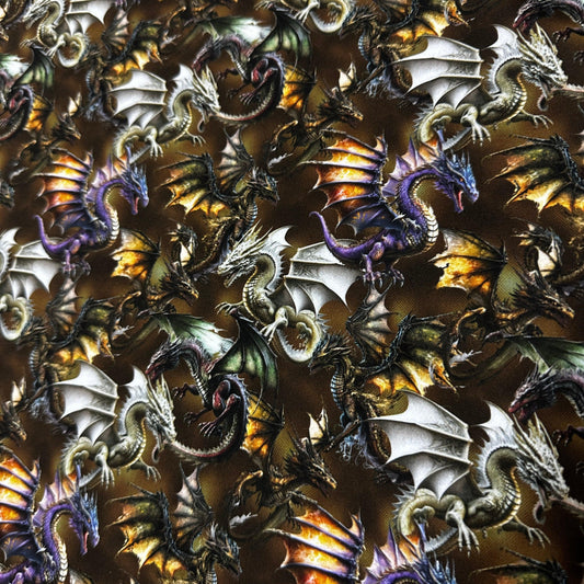 Nature's Fabrics fantasy dragon print fabric featuring multicolored dragons on a dark background
