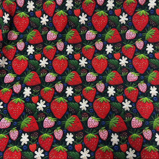 Nature's Fabrics embroidered cotton fabric with red strawberries, blueberries, and white flowers.