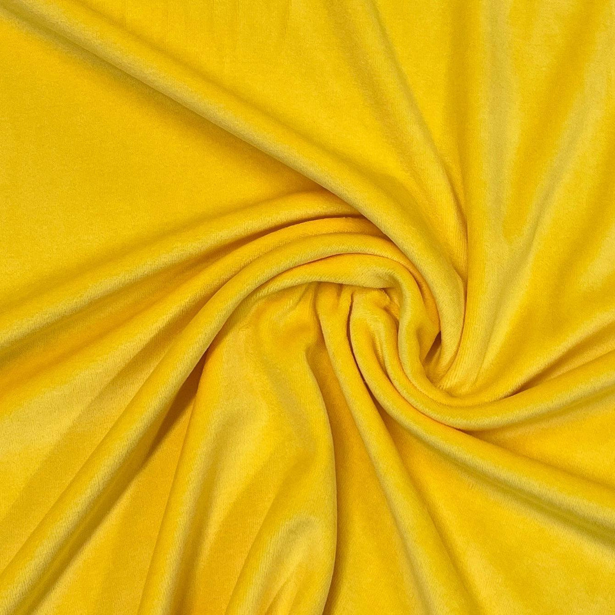 Yellow velvet fabric draped in folds from Nature's Fabrics