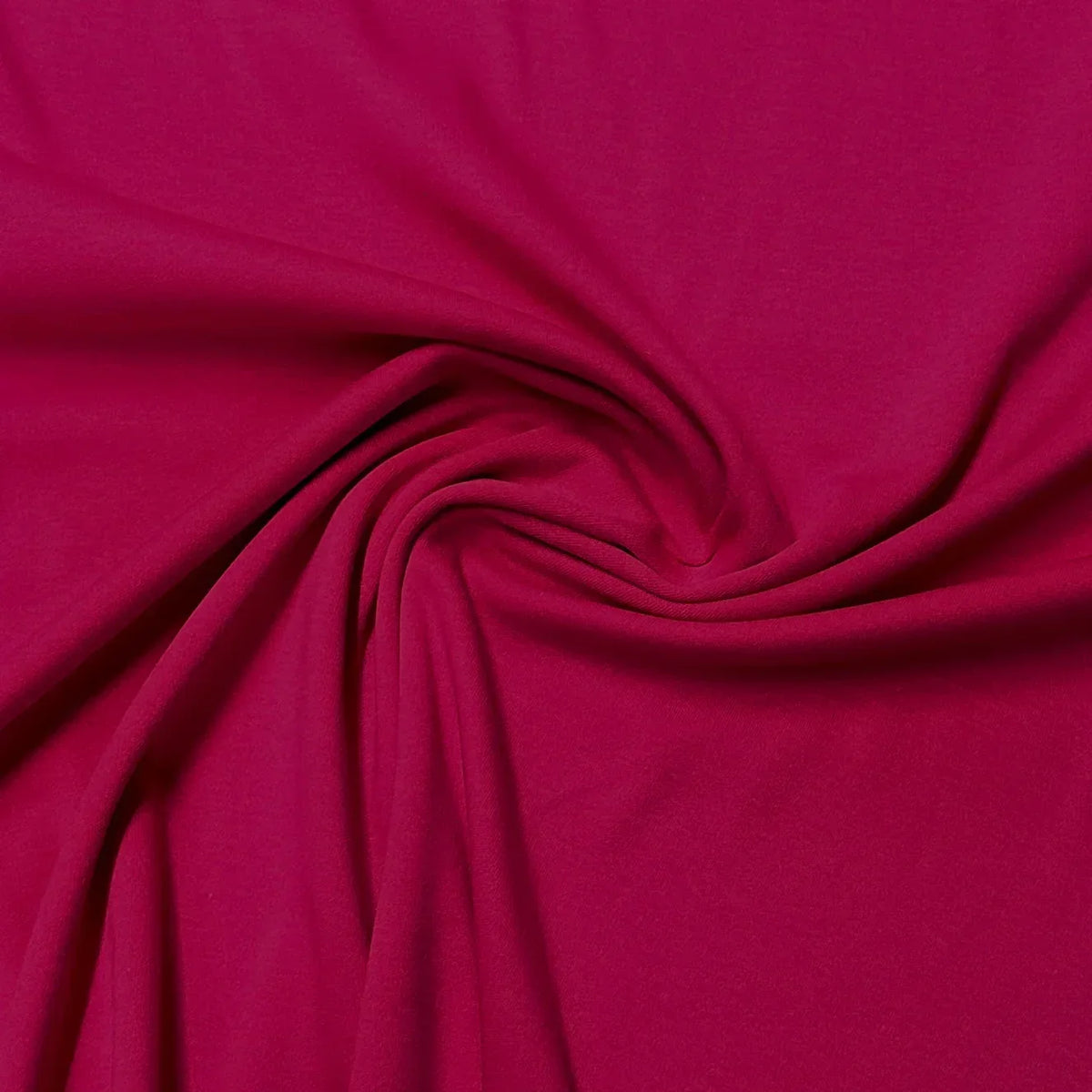 Swirl of premium magenta fabric from Nature's Fabrics.
