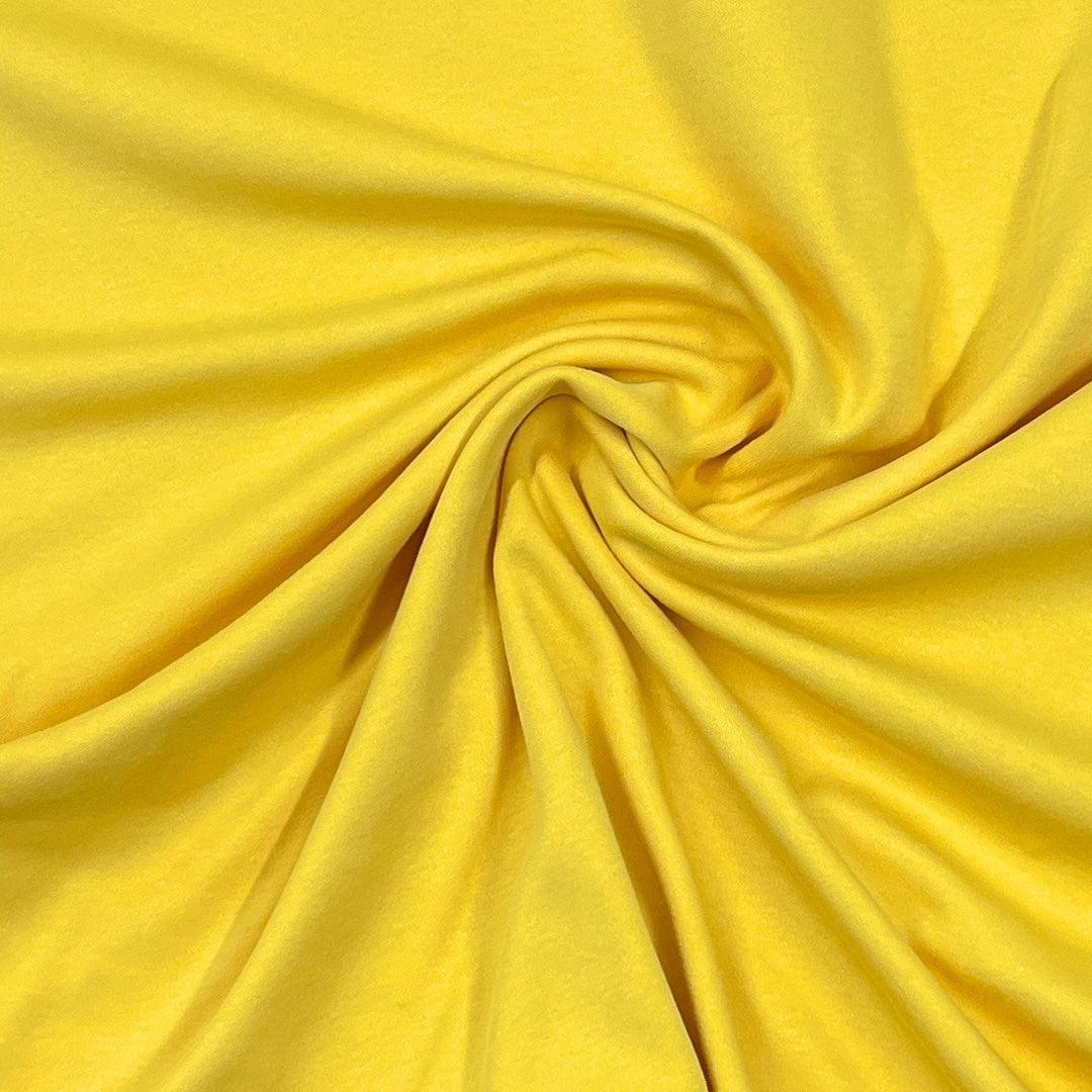 Nature's Fabrics yellow natural fabric draped in a soft swirl