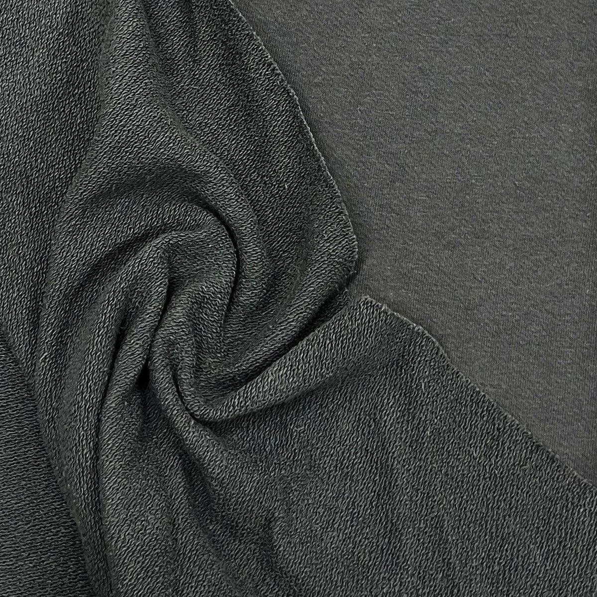 Close-up of textured charcoal grey organic fabric by Nature's Fabrics