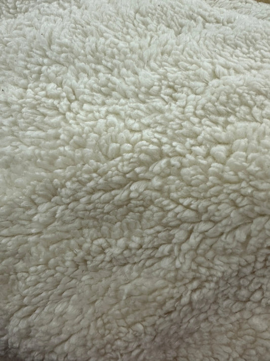 Close-up of white textured sherpa wool fabric from Nature's Fabrics.