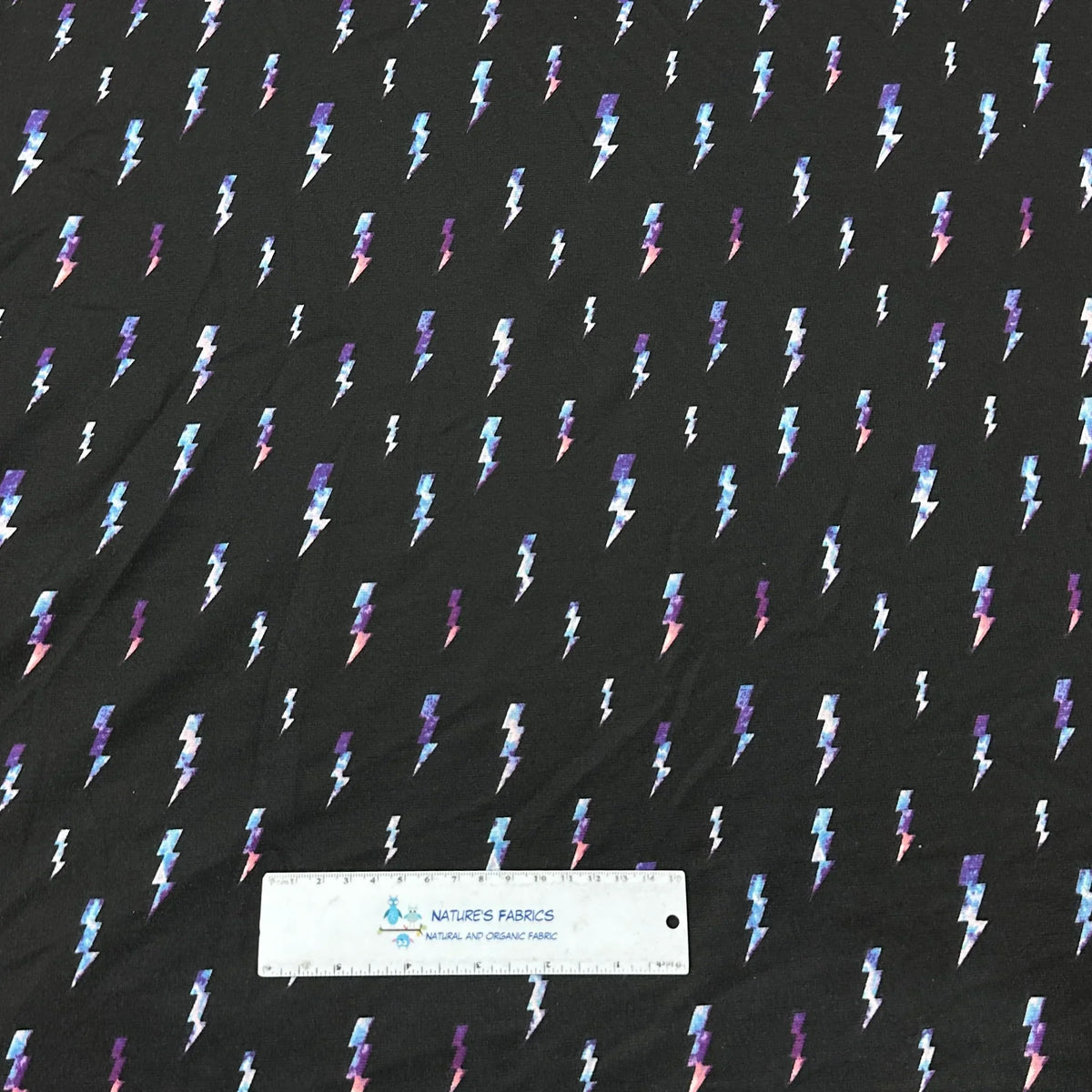 Black Nature's Fabrics material featuring a colorful lightning bolt pattern.