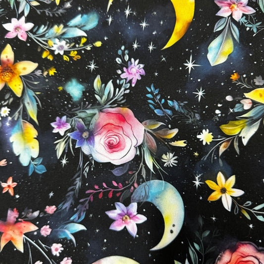 Nature's Fabrics celestial floral print fabric with roses, moons, and stars on black background